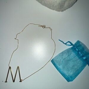 anthropology gold M slanted necklace